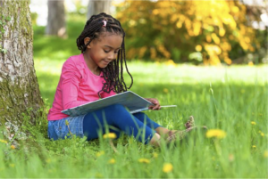 Girl reading book outside