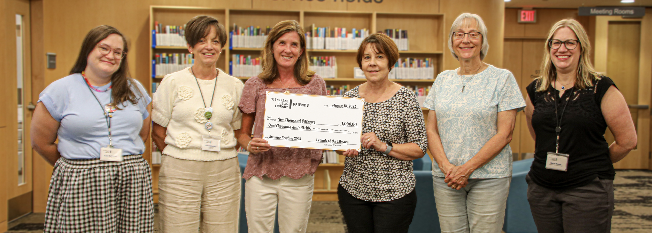 The Friends of the Library present a check to Ten Thousand Villages